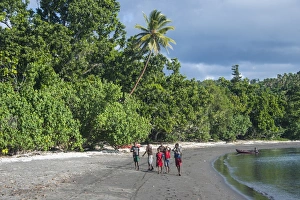 Local boys walking on a pretty black sand volcanic beach, Epi Island, Shepherd Islands Local boys walking on a pretty black sand volcanic beach, Epi Island, Shepherd Islands
