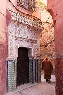Local man dressed in traditional djellaba walking through street in the Kasbah, Marrakech Local man dressed in traditional djellaba walking through street in the Kasbah, Marrakech