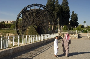Local people near water wheel on the Orontes River Local people near water wheel on the Orontes River