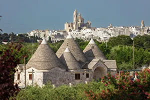 Places Of Worship Gallery: Locorotondo town and Chiesetta Rettoria Maria SS Annunziata church on hilltop with trulli house below in the Valle d'Itria