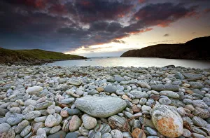Looking out to sea at sunset across the rocky beach at Gearranin, Isle of Lewis Looking out to sea at sunset across the rocky beach at Gearranin, Isle of Lewis