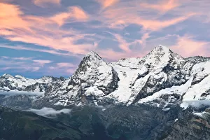 Majestic mountains Eiger and Monch under pink clouds at sunset, Murren Birg Majestic mountains Eiger and Monch under pink clouds at sunset, Murren Birg