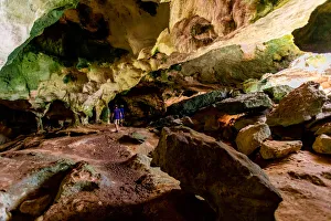 Man exploring sea caves on North Caicos, Turks and Caicos Islands, Atlantic Man exploring sea caves on North Caicos, Turks and Caicos Islands, Atlantic
