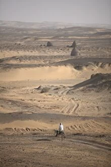 Images Dated 9th January 2000: A man on mule-back traverses the desert around the