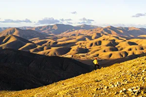 Man on ridge admiring sunset over the volcanic landscape near Sicasumbre viewpoint Man on ridge admiring sunset over the volcanic landscape near Sicasumbre viewpoint