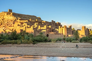 Man riding a horse in front of Ksar of Ait Ben Haddou (Ait Benhaddou) Man riding a horse in front of Ksar of Ait Ben Haddou (Ait Benhaddou)
