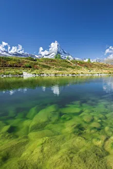 Matterhorn peak covered with snow reflected in the clear water of lake Leisee, Sunnegga Matterhorn peak covered with snow reflected in the clear water of lake Leisee, Sunnegga