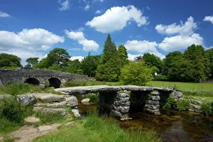 Medieval clapper bridge made of four massive granite slabs crossing the East Dart River Medieval clapper bridge made of four massive granite slabs crossing the East Dart River