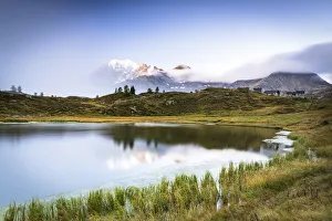 Mist on Fletschhorn and Galehorn mountains reflected in Hopschusee lake at dawn Mist on Fletschhorn and Galehorn mountains reflected in Hopschusee lake at dawn