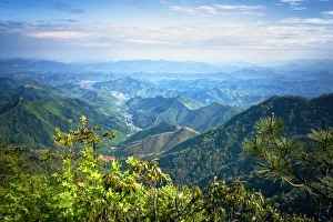 Misty mountain chains and valley with village as seen from Tian Mu Shan peak, Zhejiang Misty mountain chains and valley with village as seen from Tian Mu Shan peak, Zhejiang