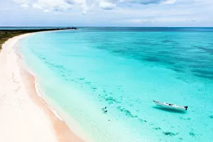 Drone Point Of View Gallery: Mother and son swimming in the crystal sea next to a pink sand beach, aerial view, Barbuda
