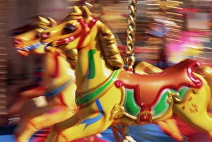 Blur Gallery: Motion blur of brightly painted merry go round (carousel) horses at speed