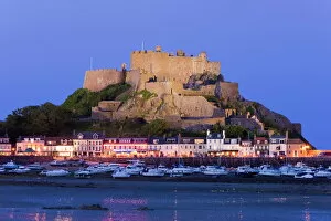 Images Dated 3rd June 2009: Mount Orgueil Castle, illuminated at dusk, overlooking Grouville Bay in Gorey