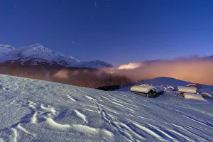Mountain huts covered with snow under the starry winter sky, Andossi, Madesimo Mountain huts covered with snow under the starry winter sky, Andossi, Madesimo
