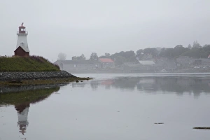 Mulholland Point Light, a lighthouse in fog, overlooking the Lubec Narrows, on Campobello