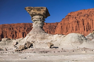 The Mushroom rock formation by Los Coloradas red rock wall, Valley of the Moon (Valle de la Luna) The Mushroom rock formation by Los Coloradas red rock wall, Valley of the Moon (Valle de la Luna)