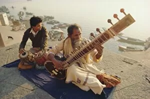 Musicians playing the Sitar and Tabla on the banks