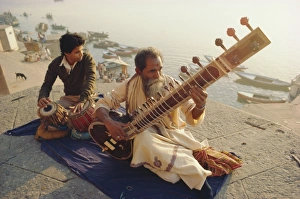Musicians playing the Sitar and Tabla on the banks Musicians playing the Sitar and Tabla on the banks