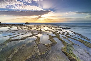 Natural pools and rocks in the surreal beach of El Cotillo lit by sunset, Fuerteventura Natural pools and rocks in the surreal beach of El Cotillo lit by sunset, Fuerteventura