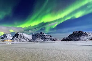 Prints of Northern Lights (aurora borealis) illuminate the sky and the snowy peaks, Flakstad, Lofoten Islands, Arctic, Norway, Scandinavia, Europe Norway Prints: Northern Lights Print over Snowy Peaks