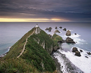 Nugget Point lighthouse on the coast and overcast sky Nugget Point lighthouse on the coast and overcast sky