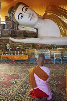 Nun in front of reclining Buddha statue, Shwethalyaung, Bago (Pegu), Myanmar (Burma), Asia Nun in front of reclining Buddha statue, Shwethalyaung, Bago (Pegu), Myanmar (Burma), Asia