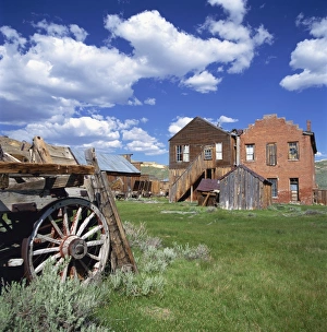 Old farm wagon and derelict wooden and brick houses Old farm wagon and derelict wooden and brick houses