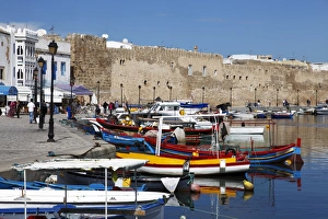 Old Port Canal, fishing boats and wall of the Kasbah, Bizerte, Tunisia Old Port Canal, fishing boats and wall of the Kasbah, Bizerte, Tunisia
