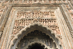 Ornate terracotta carvings of Hindu gods over the arched entrance to the Pratapeswar Ornate terracotta carvings of Hindu gods over the arched entrance to the Pratapeswar