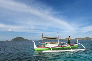 Outrigger canoe off Bahuis Island and the southern tip of Siau, Siau Island, Sangihe Archipelago, North Sulawesi Outrigger canoe off Bahuis Island and the southern tip of Siau, Siau Island, Sangihe Archipelago, North Sulawesi