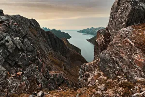 Oyfjorden fjord view from steep hiking trail through red rocks of mountains, Senja island Oyfjorden fjord view from steep hiking trail through red rocks of mountains, Senja island