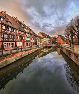 Panorama of colored houses reflected in River Lauch at sunset, Petite Venise, Colmar Panorama of colored houses reflected in River Lauch at sunset, Petite Venise, Colmar
