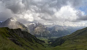 Panoramic of green valley surrounding Grindelwald and Bernese Alps lit by rainbow, First Panoramic of green valley surrounding Grindelwald and Bernese Alps lit by rainbow, First