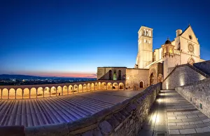 Panoramic of the illuminated arcade and Basilica di San Francesco during blue hour Panoramic of the illuminated arcade and Basilica di San Francesco during blue hour