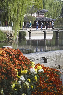People crossing footbridge in Humble Administrators Garden, UNESCO World Heritage Site People crossing footbridge in Humble Administrators Garden, UNESCO World Heritage Site