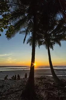 Images Dated 10th February 2012: People by palm trees at sunset on Playa Hermosa beach, far south of the Nicoya Peninsula