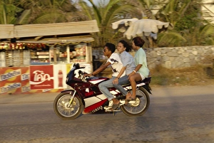 Three people riding a Yamaha motorbike at Jomtien Beach Three people riding a Yamaha motorbike at Jomtien Beach