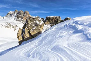 One person and natural rock arch with snow shaped by the wind in the foreground, Julier Pass, Graubunden, Switzerland One person and natural rock arch with snow shaped by the wind in the foreground, Julier Pass, Graubunden, Switzerland