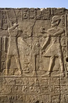 Pharaoh on right, God Amun on the left, Bas Relief, Luxor Temple Pharaoh on right, God Amun on the left, Bas Relief, Luxor Temple