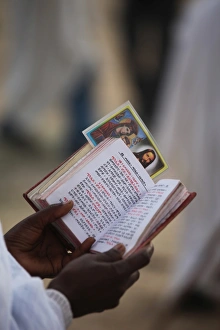 Pilgrim reading Bible in Amharic, Timkat festival, Gondar, Ethiopia, Africa Pilgrim reading Bible in Amharic, Timkat festival, Gondar, Ethiopia, Africa