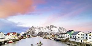 Pink Arctic sunrise over traditional houses in the fishing village of Henningsvaer in winter, Nordland, Lofoten Islands Pink Arctic sunrise over traditional houses in the fishing village of Henningsvaer in winter, Nordland, Lofoten Islands