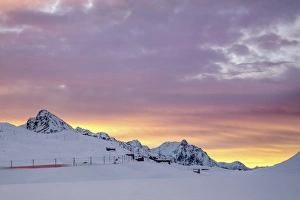 Pink clouds and snow frame the Bernina Express train at dawn, Bernina Pass, Canton of Graubunden Pink clouds and snow frame the Bernina Express train at dawn, Bernina Pass, Canton of Graubunden