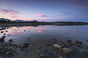 Pink clouds at sunset are reflected in the blue sea, Villasimius, Province of Cagliari Pink clouds at sunset are reflected in the blue sea, Villasimius, Province of Cagliari