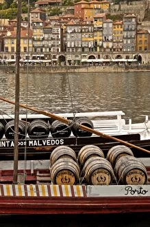 Porto Gallery: Port wine barrels on a boat on River Douro with Vila Nova de Gaia in the background
