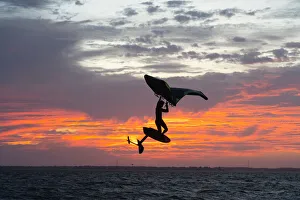 Pro surfer James Jenkins jumps his wing surfer at sunset over the Pamlico Sound at Nags Pro surfer James Jenkins jumps his wing surfer at sunset over the Pamlico Sound at Nags