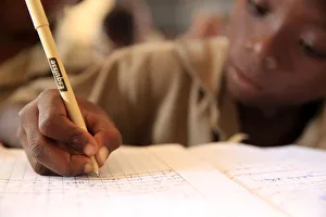 Pupil taking notes in French class in African primary school, Lome, Togo, West Africa Pupil taking notes in French class in African primary school, Lome, Togo, West Africa