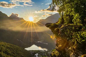 Geiranger Gallery: Last rays of sunset over Geiranger village and Geirangerfjord, UNESCO World Heritage Site