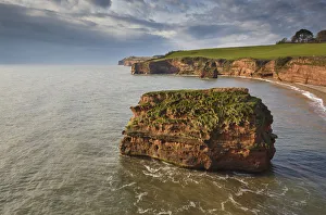 Red sandstone cliffs and rocks at Ladram Bay, in the Jurassic Coast UNESCO World Heritage Red sandstone cliffs and rocks at Ladram Bay, in the Jurassic Coast UNESCO World Heritage
