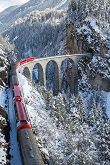 The red train of the Albula-Bernina Express Railway, UNESCO World Heritage on the famous The red train of the Albula-Bernina Express Railway, UNESCO World Heritage on the famous