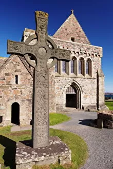 Related Images Collection: Replica of St. Johns cross stands proudly in front of Iona Abbey, Isle of Iona
